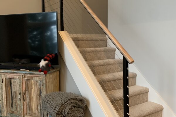 Interior cable railings topped with a wood handrail