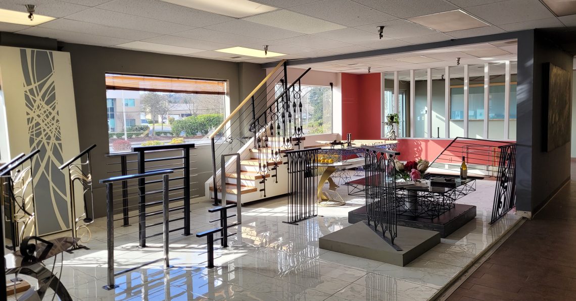 Interior view of the Custom Railings WA showroom in Kent, WA, showcasing modern and ornamental metal railings, glass railings, fences, gates and other metalwork.