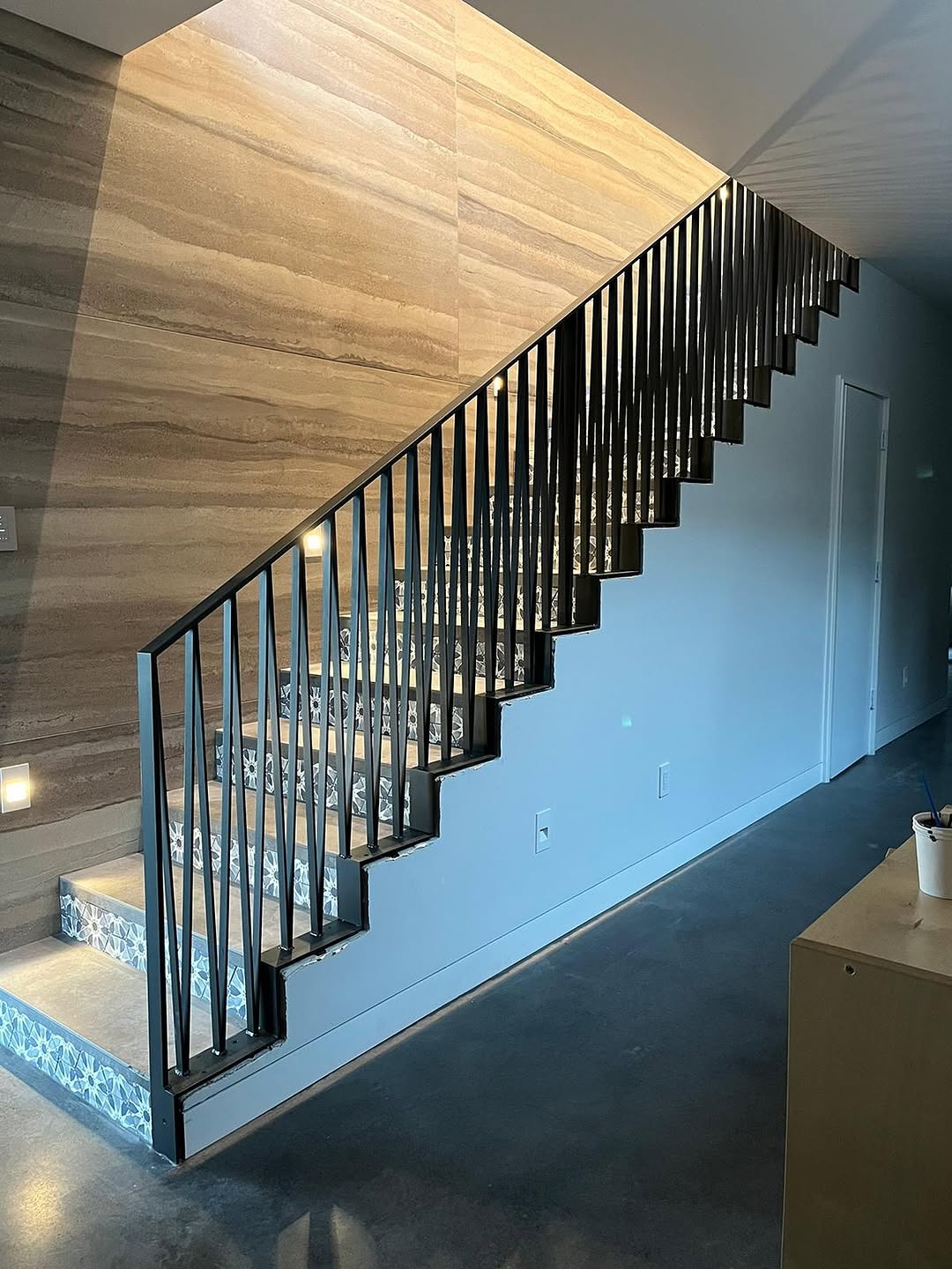 Custom black interior stair railings with vertical pickets installed on Mercer Island