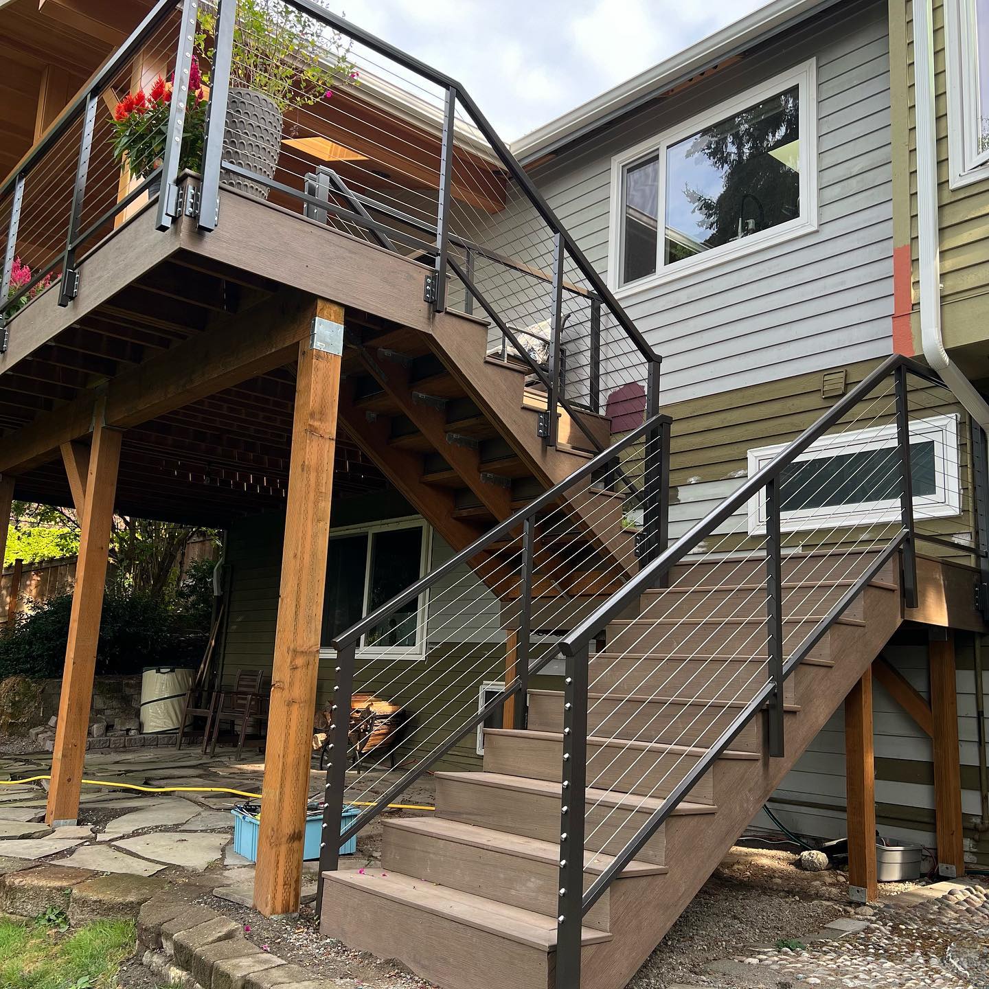 Exterior deck cable railing system with metal posts and stainless cables
