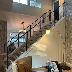 Interior cable stair railing with modern metal frame