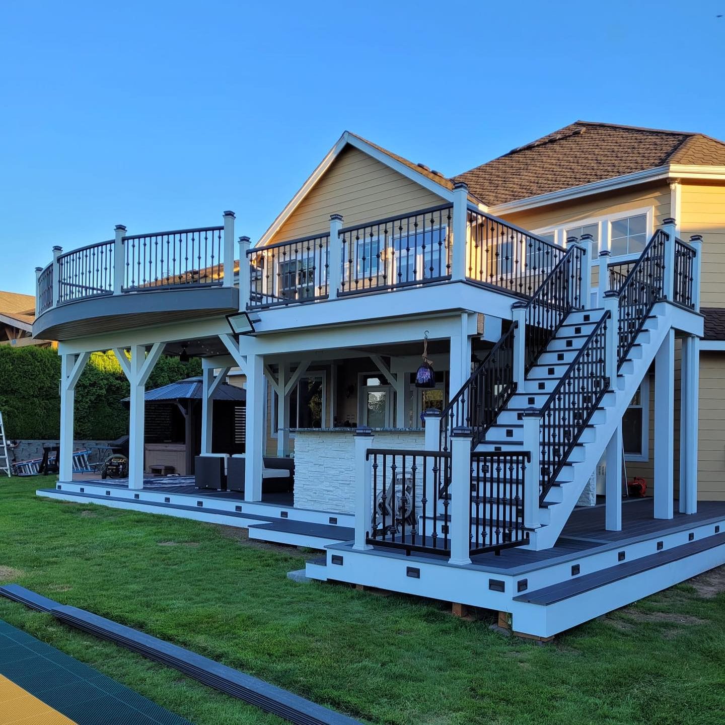 Custom black metal deck and stair railings with decorative balusters in Renton
