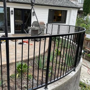 Curved black metal railing installed around a rounded patio edge in Kenmore WA