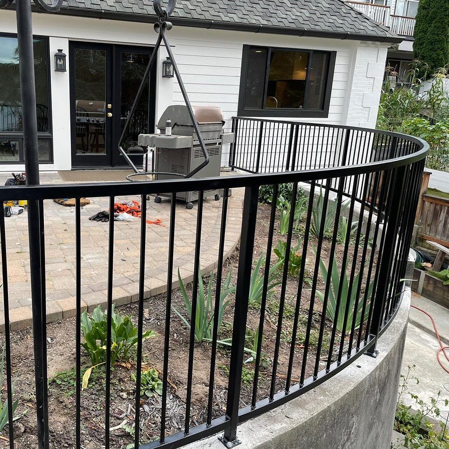 Curved black metal railing installed around a rounded patio edge in Kenmore WA