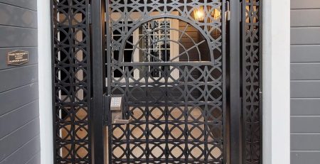 Decorative black metal security entry gate with geometric laser-cut pattern in Tacoma