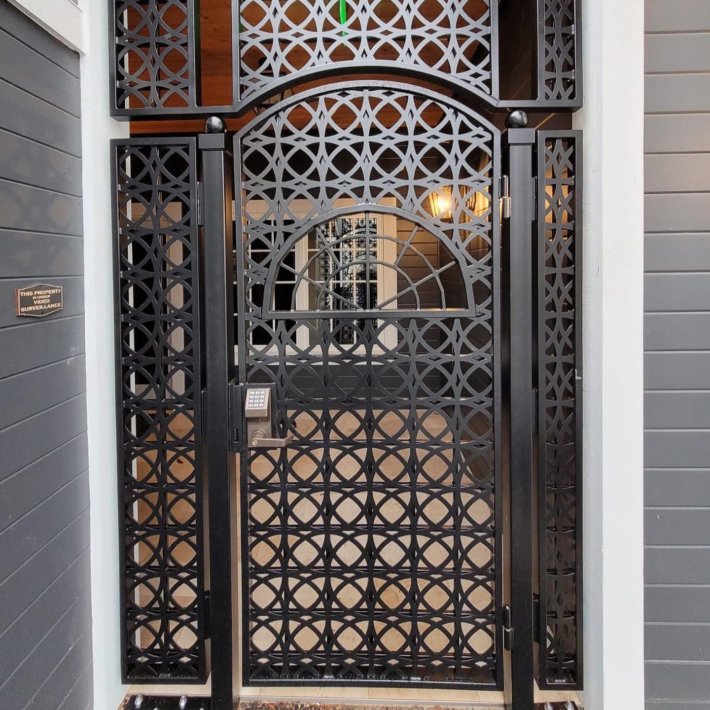Decorative black metal security entry gate with geometric laser-cut pattern in Tacoma