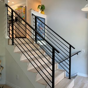 Modern interior stair railing with horizontal metal bars and square posts in Maple Valley
