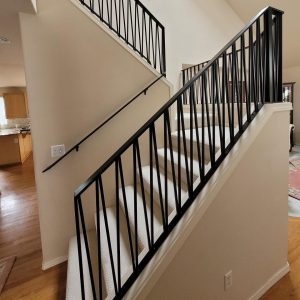 Black interior stair railings with clean lines and modern balusters in Renton, WA