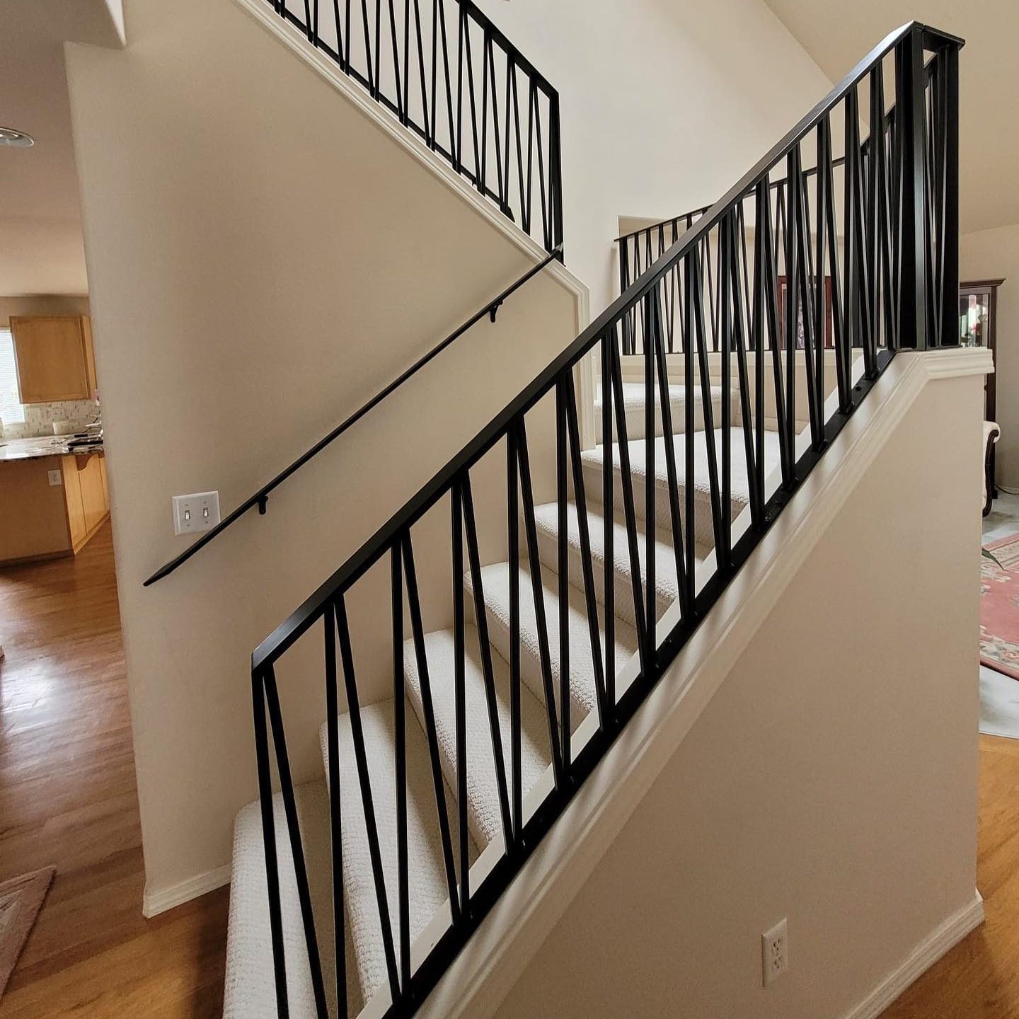 Black interior stair railings with clean lines and modern balusters in Renton, WA