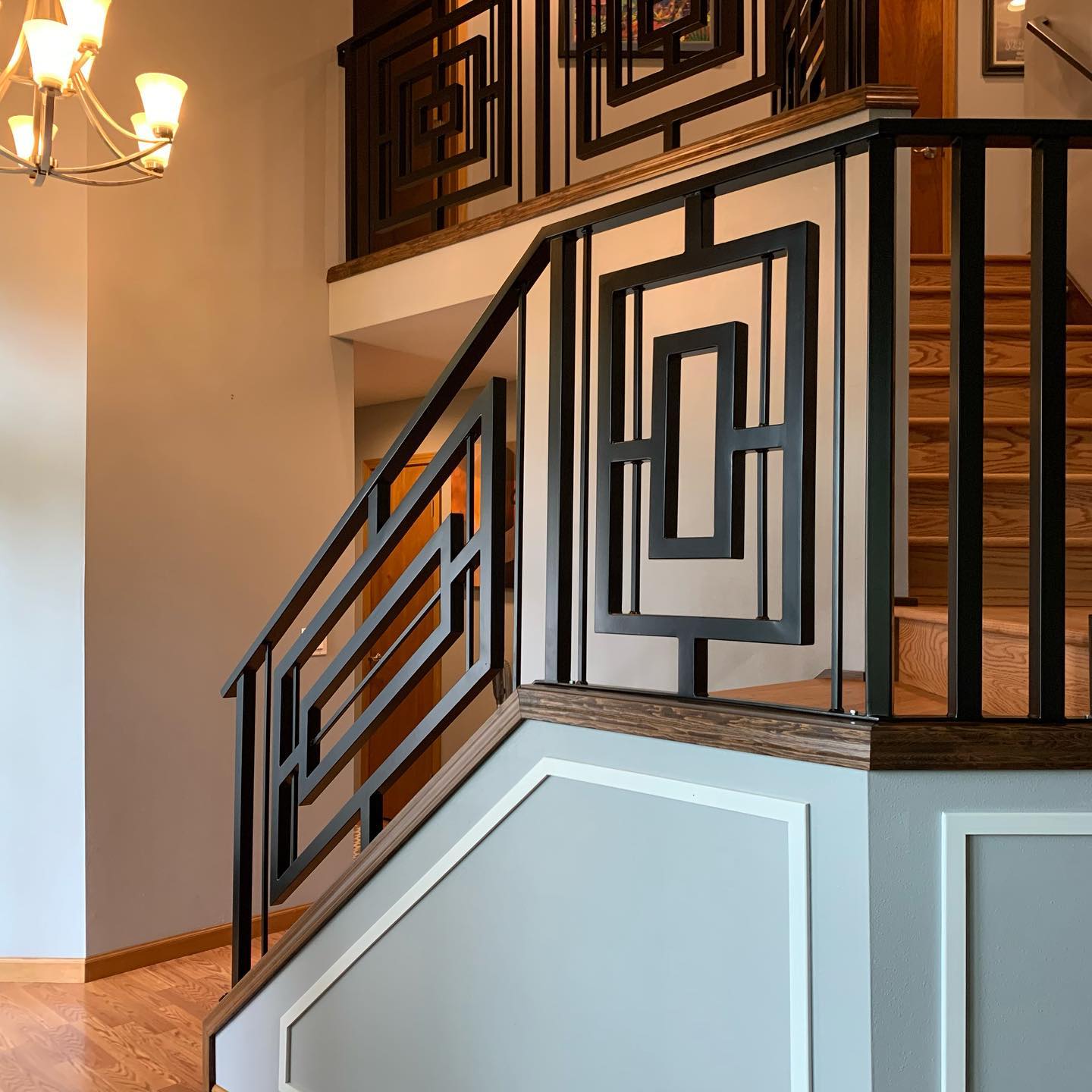 Custom geometric interior stair railing panels with wood cap rail in Shoreline