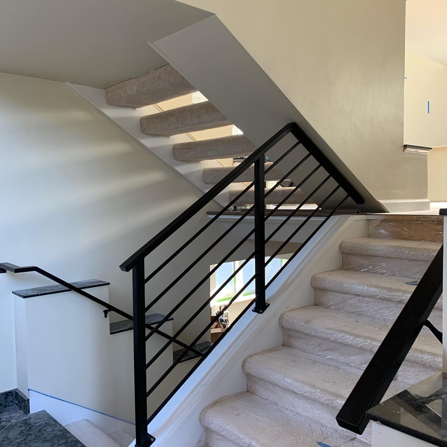 Black interior stair railing with horizontal bars and square posts in Shoreline, WA