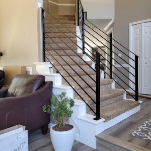 Modern black interior horizontal bar railing with square posts on staircase in Duvall, WA