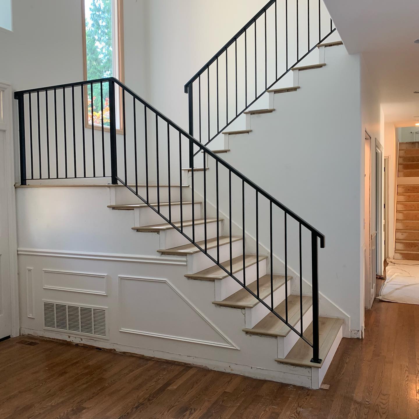 Black vertical picket interior stair railing with simple modern profile in Woodinville, WA