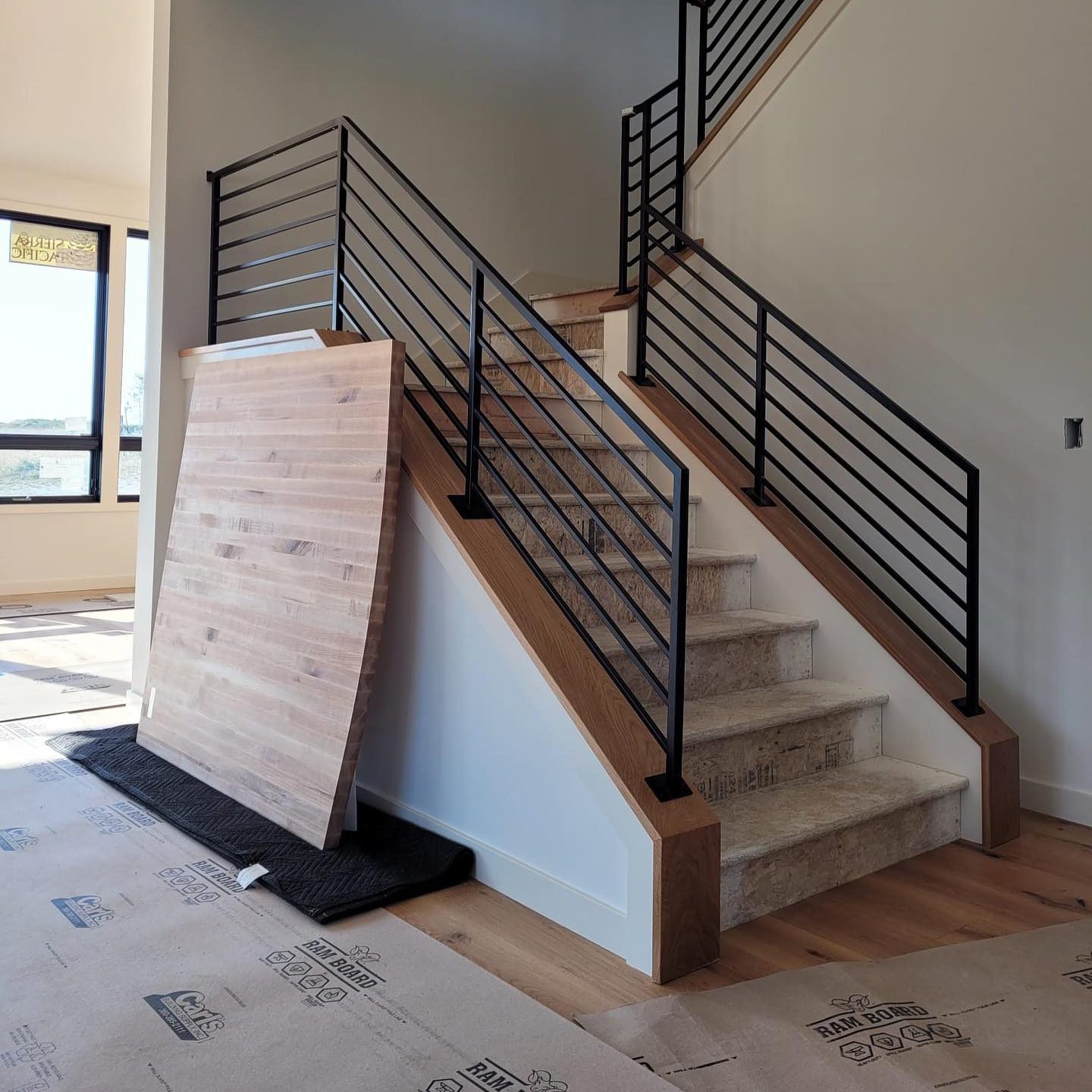 Black interior railings installed on a multi-level staircase in Port Townsend WA