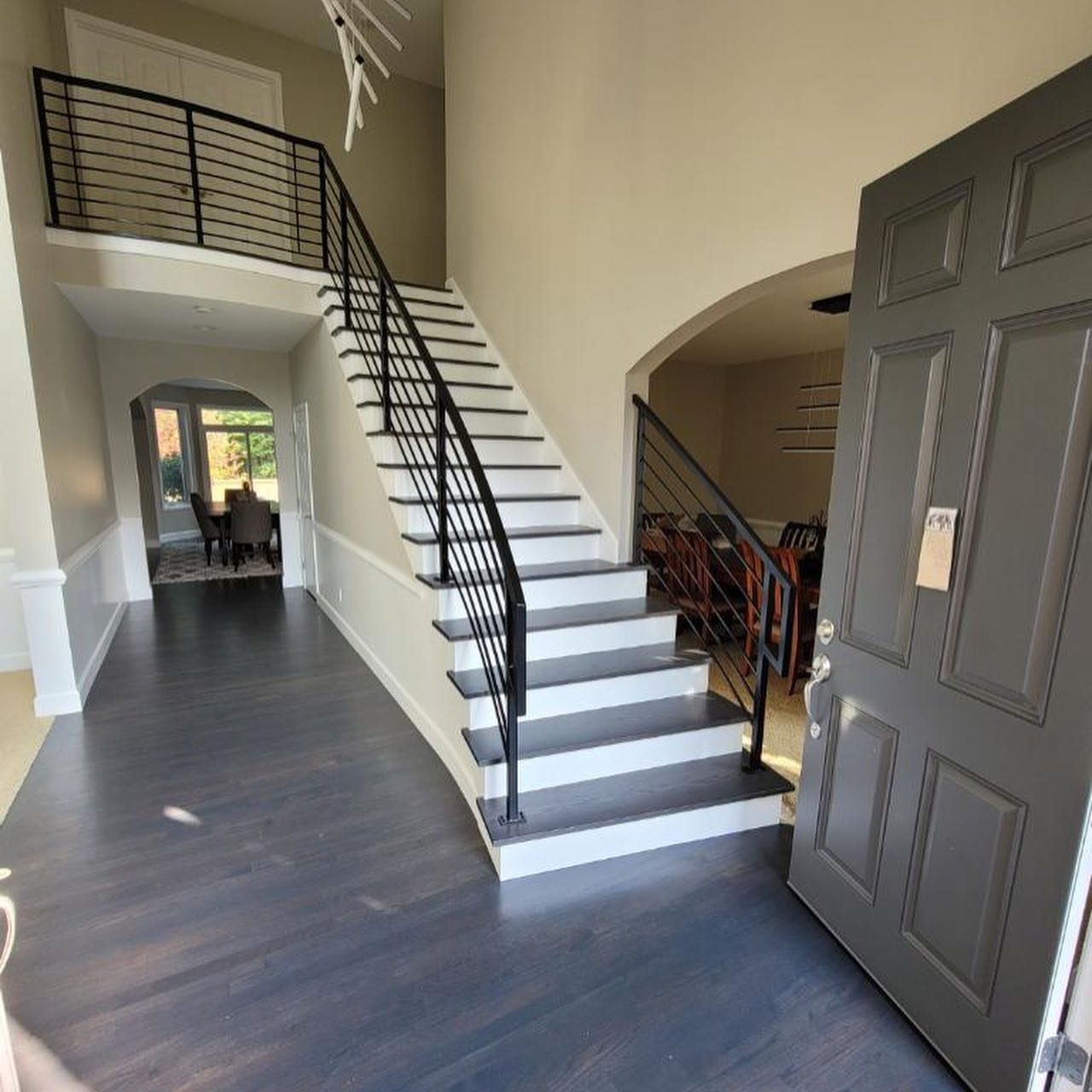 Interior railing featuring a wood handrail and metal balusters